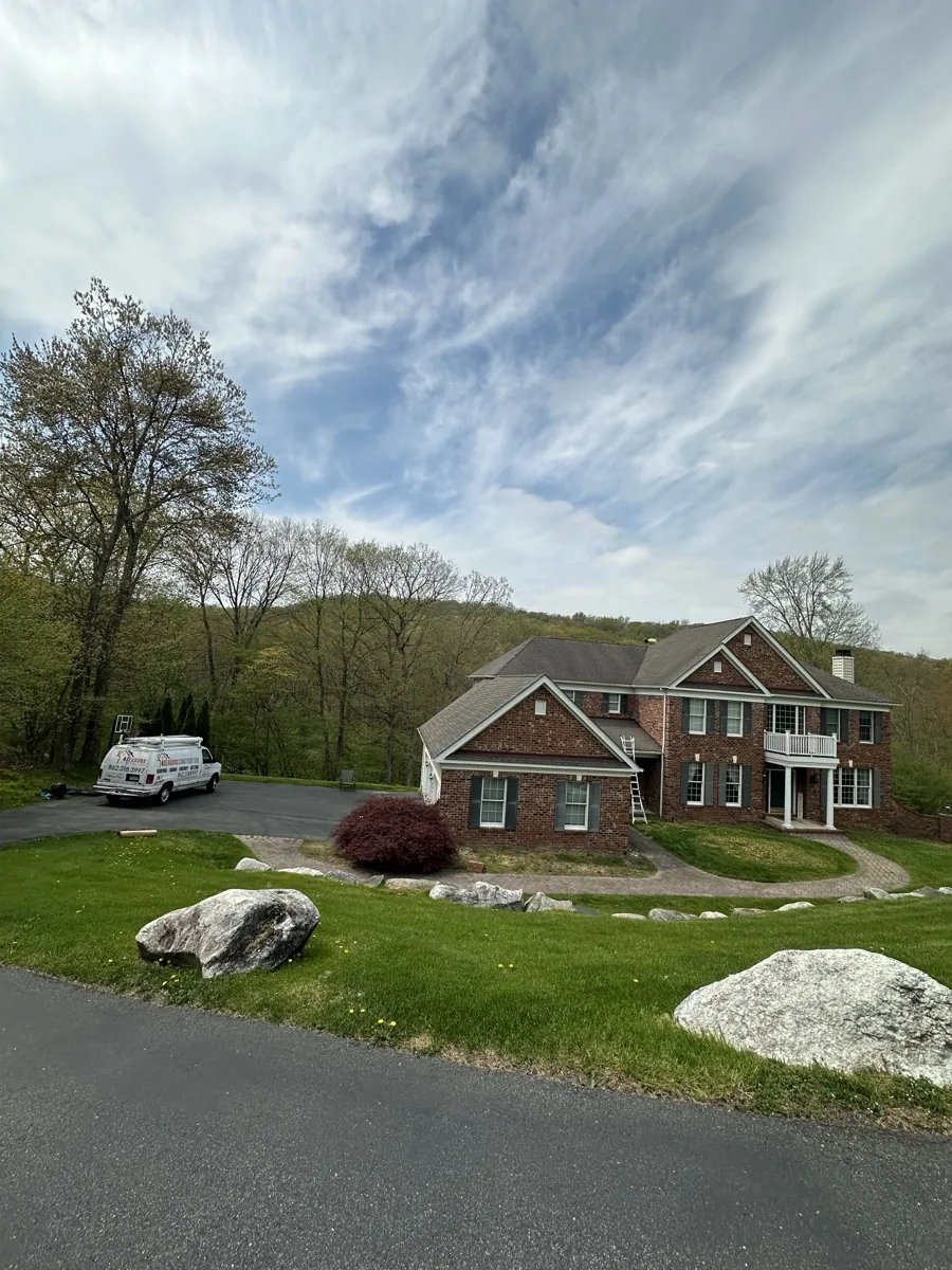 Exterior inspection of a Livingston NJ home before window and door replacement by Four Seasons Roofing and Construction