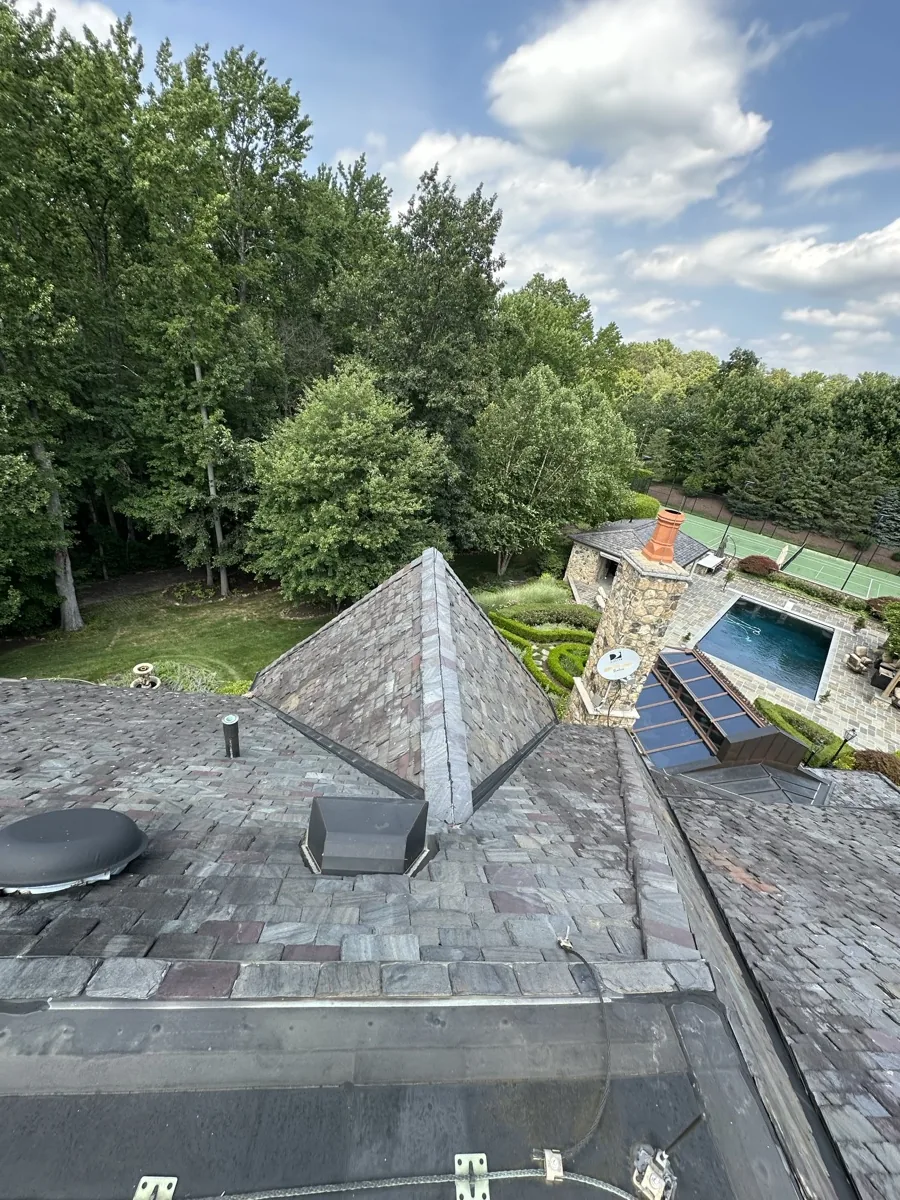 Tracing and repairing a roof leak on a North Jersey two-family home