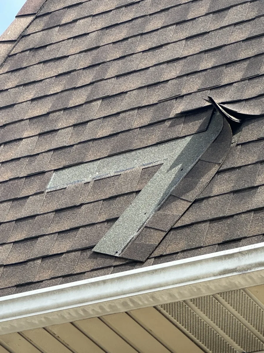 Crew repairing wind-lifted shingles after a storm in Wayne NJ
