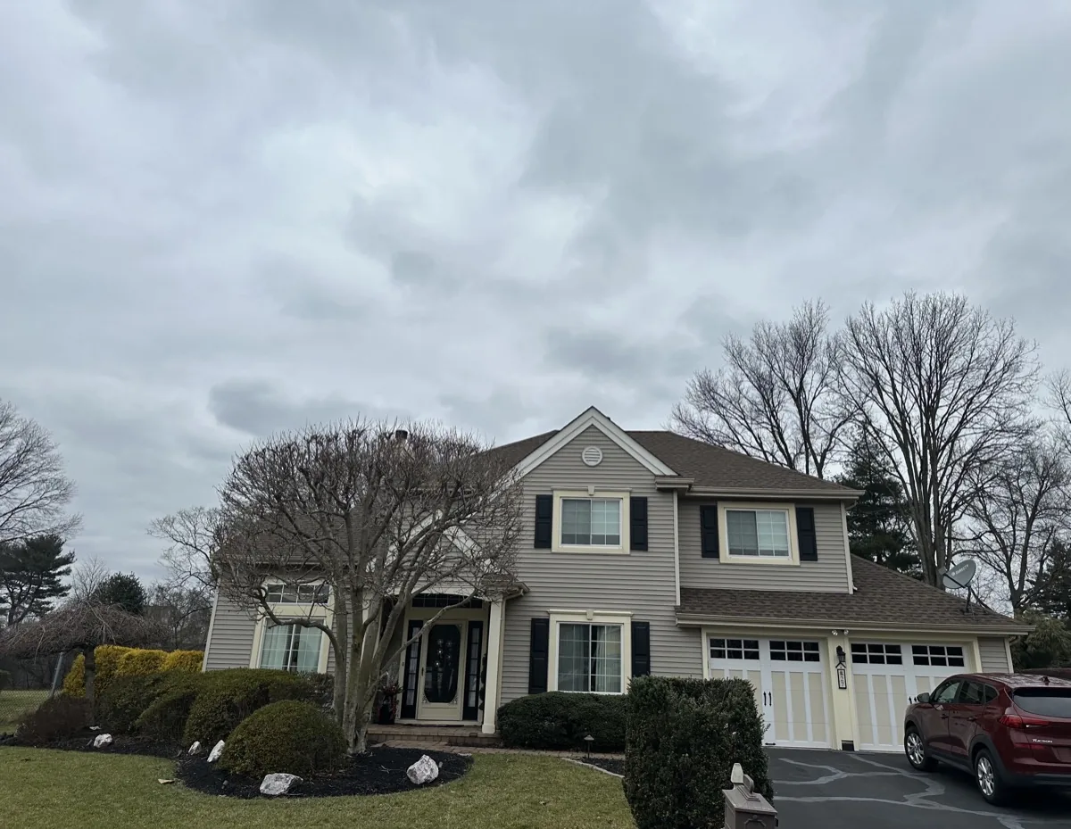 Crew repairing siding panels on a New Jersey home exterior